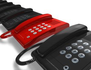 Red phone in row of black ones